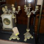 A pair of early 20th century bronze three branch, four light candelabra, with three pillar column