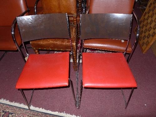 A set of eight red and black Dietiker Swiss stacking dining chairs