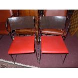 A set of eight red and black Dietiker Swiss stacking dining chairs