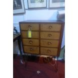 A bespoke mahogany chest with eight light oak drawers, raised on hairpin legs, H.100 W.701 D.42cm