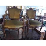 A pair of late 19th/early 20th century French walnut fauteuils, with carved frame and golden