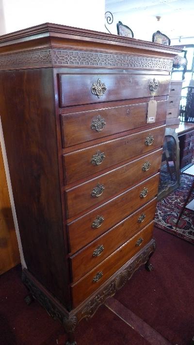 A Georgian mahogany tall boy, with seven drawers, raised on carved base having paw feet, H.166 W.