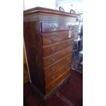 A Georgian mahogany tall boy, with seven drawers, raised on carved base having paw feet, H.166 W.