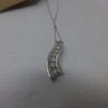 A white gold pendant with inset diamonds