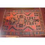 A North West Persian Hamadan rug, 215cm x 150cm, central eagle motifs pattern on a rouge field