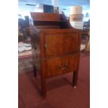 An early 19th Century George III mahogany night table, the shelved top over panelled single cupboard