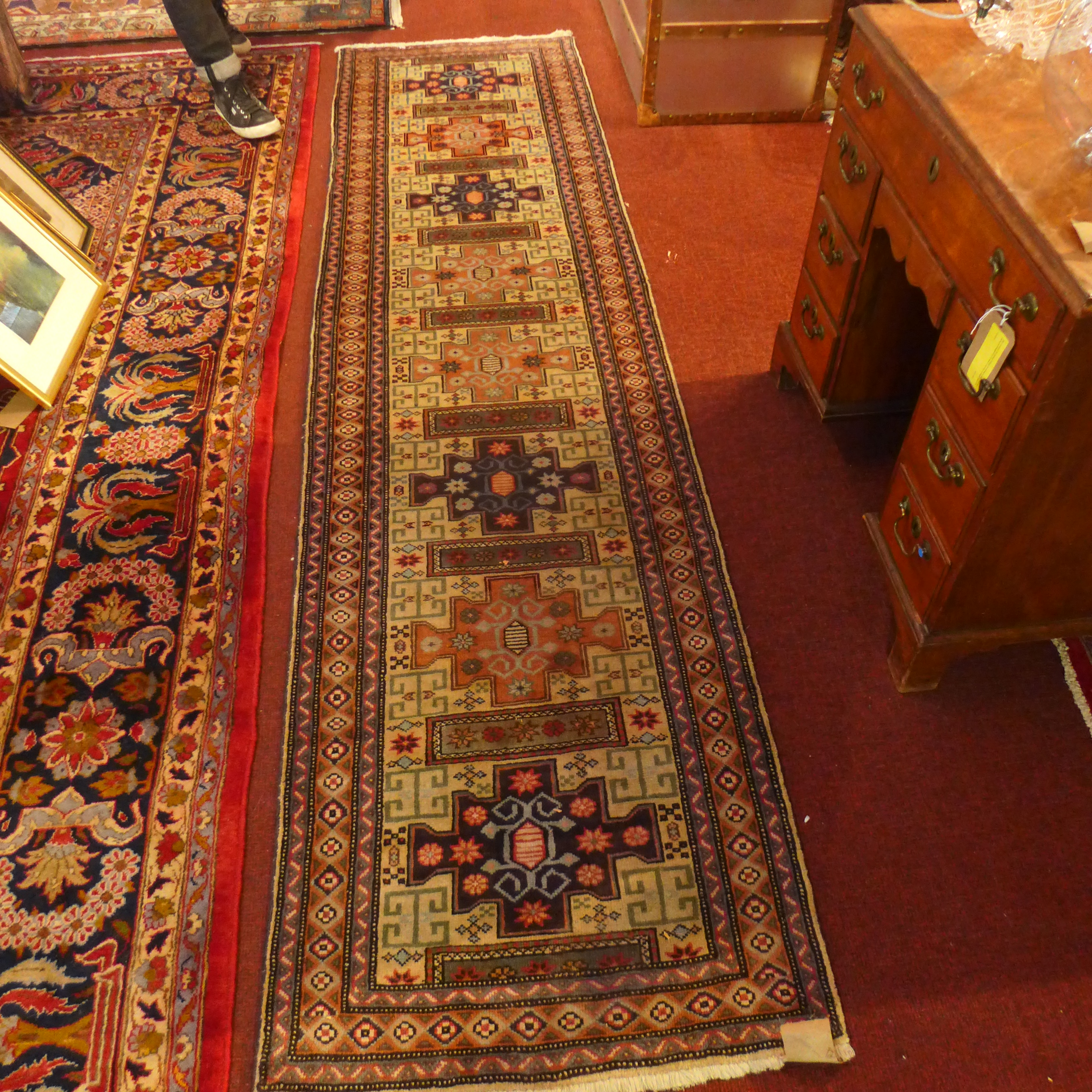 A North West Persian Heriz runner, 290cm x 73cm, repeating stylised pole medallion motifs on an