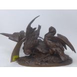A cast bronze sculpture of two birds on a naturalistic base, signed, H.23cm
