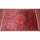 A North West Persian Zanjan rug, 213cm x 135cm, central diamond medallion on a rouge field within