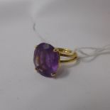 A ladies yellow metal and amethyst ring (probably gold), oval cut amethyst