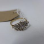 A ladies 9ct yellow gold and diamond inset ring, central round brilliant cut diamonds flanked by