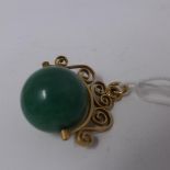 A 14ct yellow gold and jade ball pendant, stamped 585