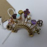 A yellow metal brooch in the unusual form of various hatpins set as a crown, each pin having a