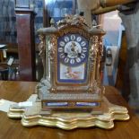 A French gilt bronze mantel clock, drum movement, architectural case with caryatid columns, wreath