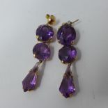 A pair of yellow metal and amethyst three drop earrings, (probably gold)