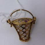 A yellow metal brooch in the form of a basket, having inset precious stones (probably gold)