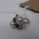 A ladies white metal, pearl and sapphire dress ring