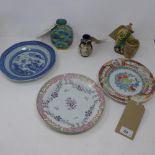 A set of three various Oriental plates, together with two vases and a porcelain figure with