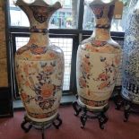 A large pair of 20th century Chinese vases, decorated with vases of flowers, with character marks to