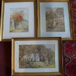 A set of three watercolours of garden scenery, one with coastal views, monogramed to lower right,