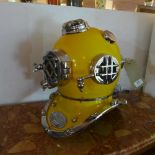 A replica model of a diver's helmet in yellow and chrome