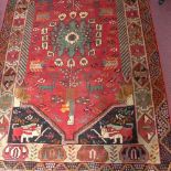 A South West Persian Qashqai rug, central diamond medallion with repeating petal and animal motifs