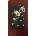 A 20th century Chinese red and black lacquered panel with mother of pearl inlaid scene with birds,