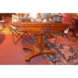 A Victorian mahogany card table, raised on pillar support and quad base