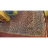 A large antique Persian kashan rug, the all over floral design within a palmette and vine stylised