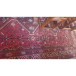 A Persian carpet, geometric designs, on a red and black ground