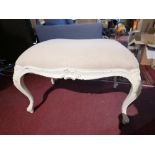 A French cream painted footstool, with grey linen upholstery over cabriole supports, H.50cm L.60cm