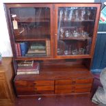 A mid 20th century Danish rosewood bookcase by Bouer Mobelfabrik, with two glazed doors enclosing