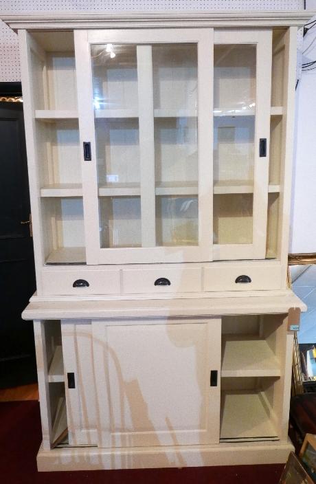 A contemporary white painted display cabinet, with twin glazed doors enclosing shelves over three