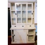 A contemporary white painted display cabinet, with twin glazed doors enclosing shelves over three