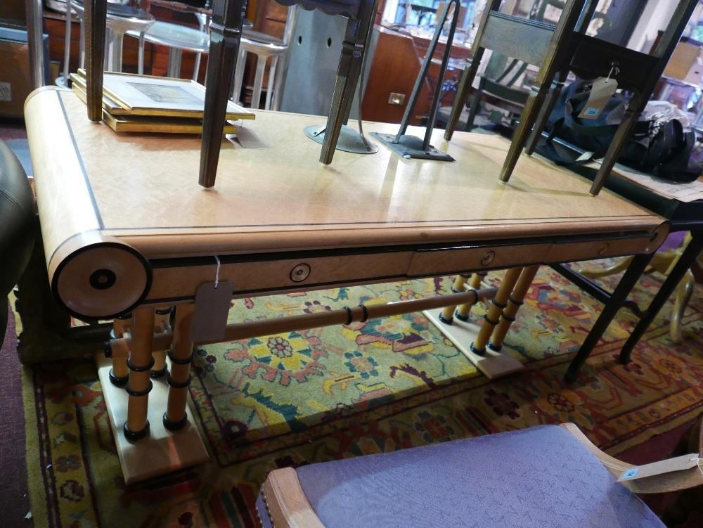 A reproduction Biedermeier maple and beechwood desk, part ebonised, with three drawers