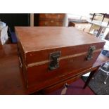 An early 20th Century Chinese tan leather bound trunk with twin carrying handles, H.35cm L.82cm D.