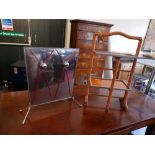 A vintage chrome etagere with orange glass shelves, together with an associated chrome fire guard (