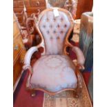 A 19th century, carved mahogany armchair upholstered with silk damask and with button-back