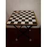 A contemporary Oka folding side table, with chequered top, H.61 W.40 D.40cm