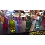 A set of six multi coloured glass soda syphons