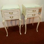 A pair of Louis XV style white painted side chests, glass tops above two small drawers, on