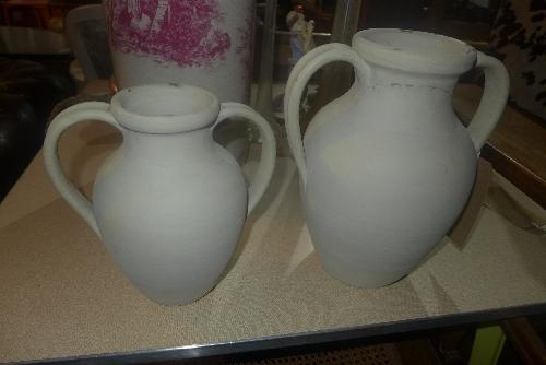 Two twin handled ceramic urns, H.30cm and H.24cm (2)