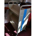 A mid 20th Century cream painted metal library bookshelf on wheels, by Luxor, H116cm W.73cm D.43cm