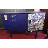 A contemporary blue painted sideboard, by Schreiber, with a floral printed door flanking three