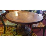 A William IV mahogany and walnut tilt top breakfast table, raised on fluted column, circular base