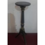 An early 20th Century Regency style ebonised pedestal raised on tripod supports, H.110cm