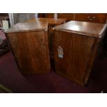 A pair of Art Deco walnut side cabinets with fitted cupboard doors on plinth bases, H.60cm W.40cm