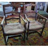 A pair of early 20th Century oak open armchairs with ladder backs and rush seats, H.95cm (2)