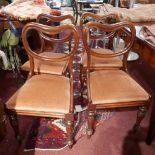 A set of four Victorian mahogany dining chairs with pink velour upholstery raised on reeded baluster