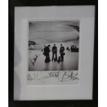 A signed U2 print, of the 'all that you can leave behind' 2000 album, set in a black frame , H.56